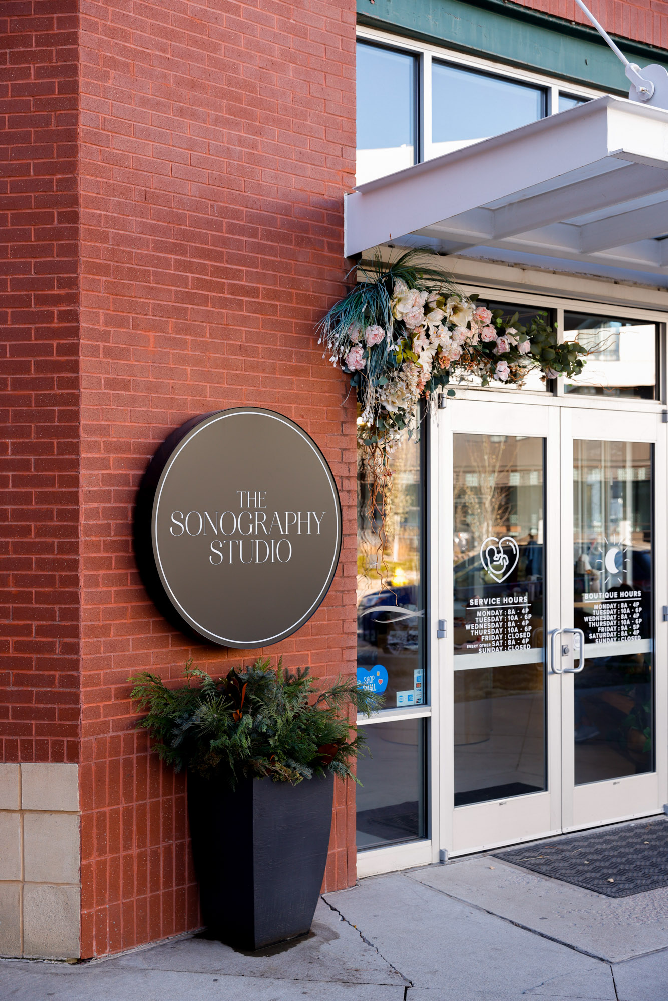 The brick exterior and double doors of The Sonography Studio, a menopause specialist in Panama City.