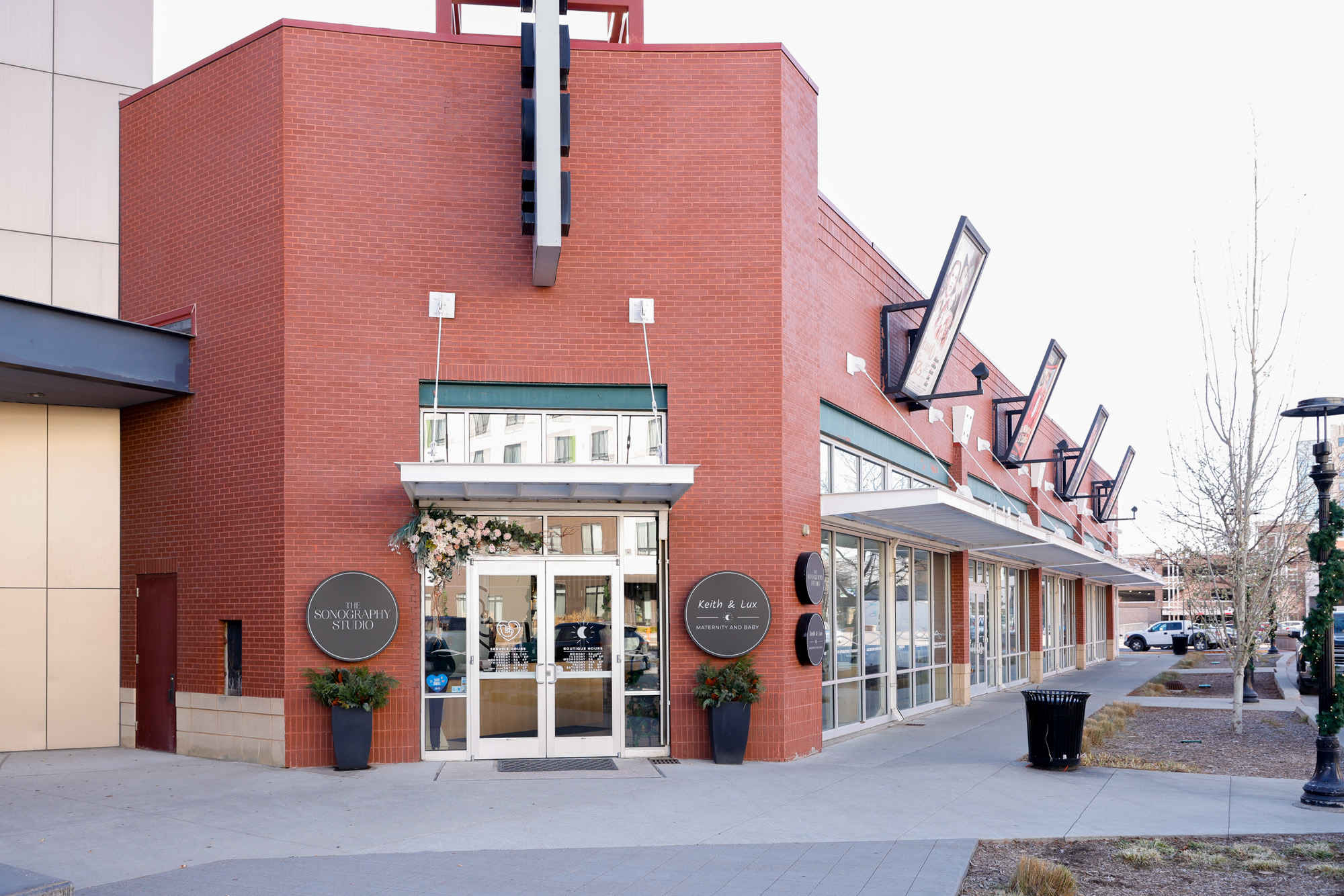 Exterior of The Sonography Studio, a red brick building with double doors.