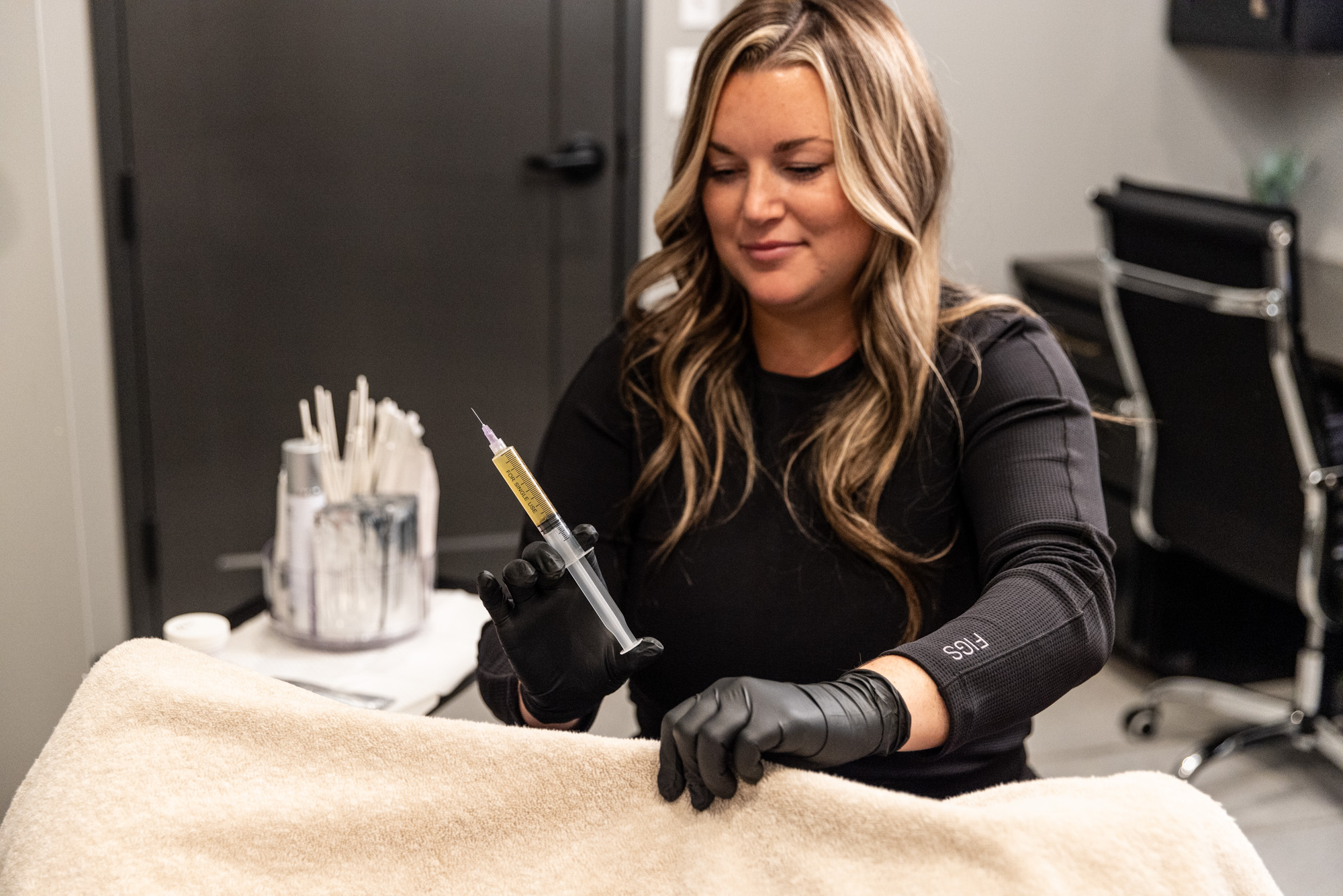 A provider at The Sonography studio, a women's clinic in Sioux City, preparing to perform a vaginal rejuvenation treatment.